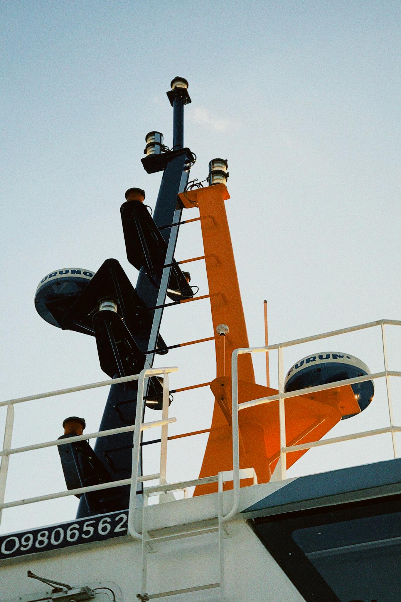 A vibrant ship antenna and radar array against a clear sky, offering nautical technology insights.
